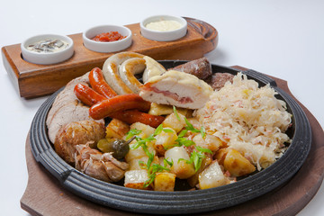 grilled sausages and potatoes on cooking pan
