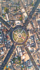Road roundabout with car lots Wongwian Yai in Bangkok,Thailand. street large beautiful downtown at evening light.  Aerial view , Top view ,cityscape ,Rush hour traffic jam