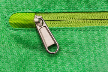 Metal zipper on green bag.