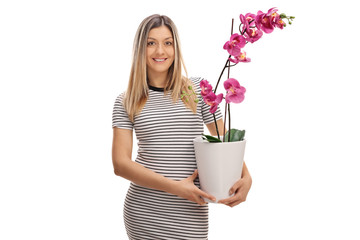 Young woman holding an orchid flower in a pot