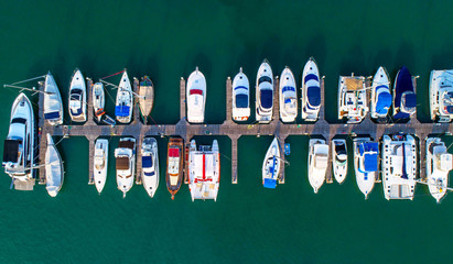 Obraz premium Pier speedboat. A marina lot. This is usually the most popular tourist attractions on the beach.Yacht and sailboat is moored at the quay.Aerial view by drone.Top view.