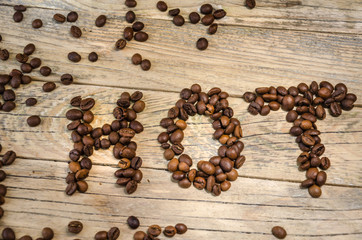 Hot. Roasted Coffee beans on natural wooden background