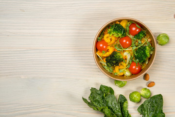 Salad for vegetarian, vegan food, vitamin snack and health life. Top horizontal view on light wood background and copy space. White overhead flat food photo. 