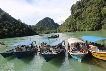 Fototapeta na wymiar Boats are parked at river bank Langkawi(Malaysia)