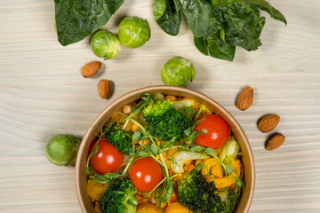 Detox salad for vegetarian, vegan food, vitamin snack and health life. Top horizontal view on light wood background and copy space. White overhead flat food photo. 