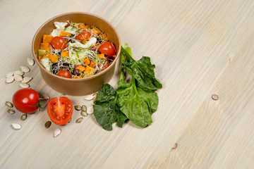 Detox salad for vegetarian, vegan food, vitamin snack and health life. Top horizontal view on light wood background and copy space. White overhead flat food photo. 