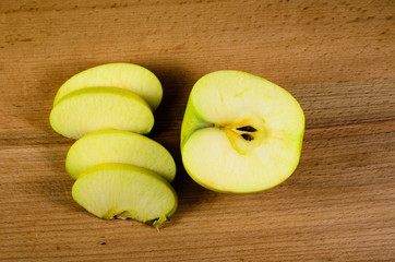 Sliced green apple on wooden table