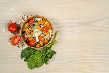 Detox salad for vegetarian, vegan food, vitamin snack and health life. Top horizontal view on light wood background and copy space. White overhead flat food photo. 