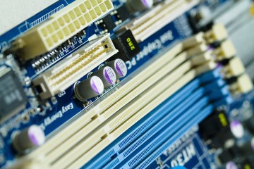 Detail of memory slots and power supply connector of dusty used PC motherboard