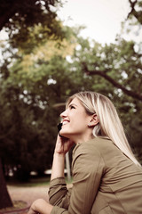 Caucasian woman using mobile phone outdoor.