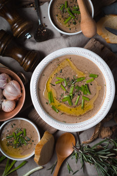 Mushroom cream soup on the rustic background top view