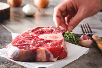 Preparing meat plate on wooden background
