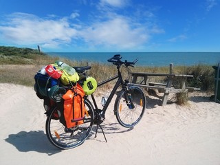 Fully loaded bike at the beach during a bike tour