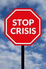 Stop crisis. Text on red traffic stop sign in rear of cloudy blue sky. Concept.