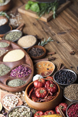 various dry spices on a wooden table