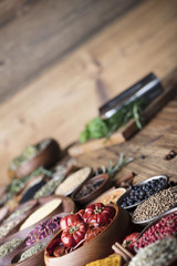 various dry spices on a wooden table