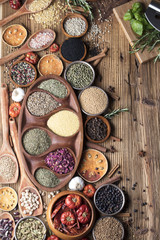 various dry spices on a wooden table