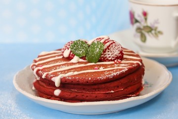 Stack of Red velvet pancakes against blue background, selective focus