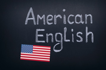 Hand drawing American English on blackboard