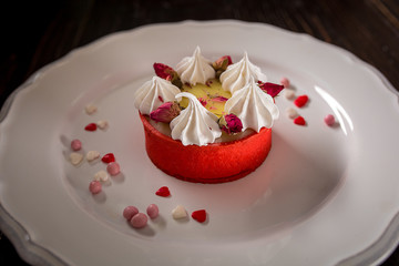 Caramel cheesecake with cream and flowers on the wooden background