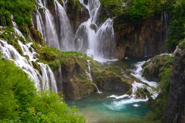 Foto op Plexiglas Massive waterfall among lush foliage © ggaallaa