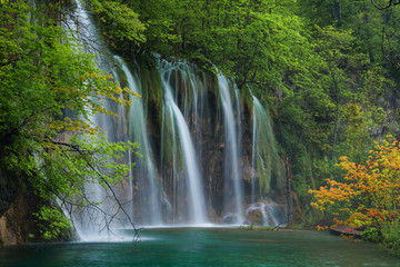 Waterfall, lake and orange tree