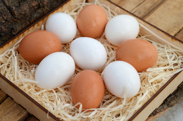 Nine chicken eggs in carton. Eggs for Easter. Wooden background