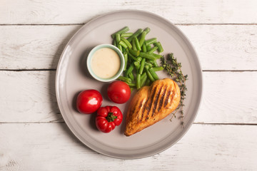 Marinated grilled healthy chicken breast served with vegetables