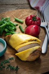 Prepared healthy chicken breast with melted cheese served with vegetables