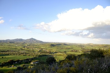 Fototapeta na wymiar Green landscape of Stavrovouni mountain and cloudy sky