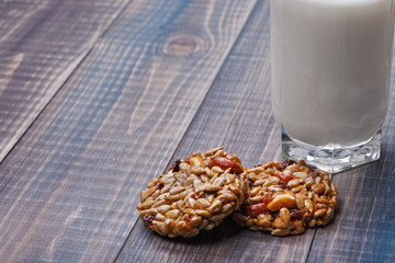 Gozinaki - Sweets from seeds and nuts lie on the table. Nearby is a glass of milk