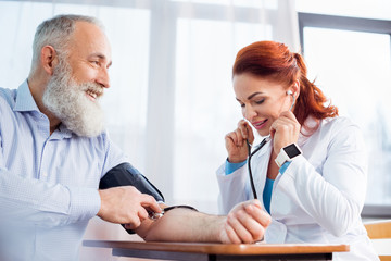 Doctor measuring pressure of patient