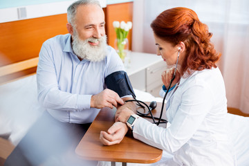 Obraz premium Doctor measuring pressure of patient