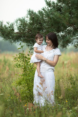 emotional mother with daughter in arms, motherhood