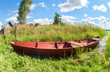 Wooden boat for fishing at the lake in summer sunny day