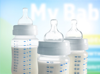 Baby milk bottles on white background