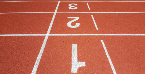Close up running track with three lanes.