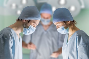 Surgeons during operating in surgery room.