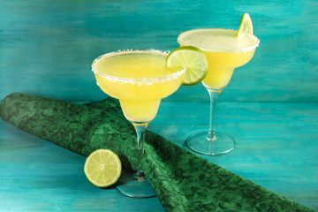 Lemon Margarita cocktails with limes and copyspace