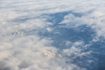 Aerial view of snowy mountains and clouds