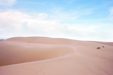 Fototapeta na wymiar Desert landscape dunes in the afternoon with blue skies white clouds and nobody around, Vietnam asia.
