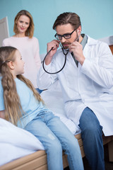 Mother and daughter visiting doctor