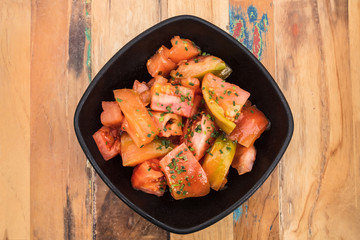 Ripe raf tomatoes and chives salad with copyspace