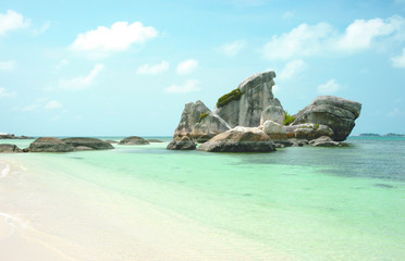 Fototapeta na wymiar Natural rock formation in the sea and on a white sand beach in Belitung Island in the afternoon, Indonesia.