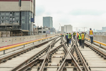 Fototapeta na wymiar Engineer walk on track or railway on viaduct of sky train for inspect trackwork