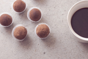 HOmemade cocoa truffles with cup of coffee
