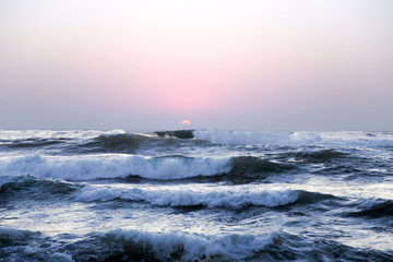 Large waves of the Atlantic Ocean on a sunset background  in Lisbon, Portugal
