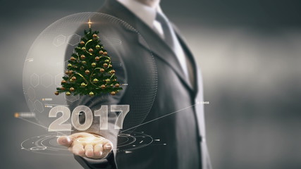 2017 Christmas tree Businessman Holding in Hand New technologies - Powered by Adobe