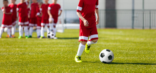 Soccer Football Training for Kids. Youth Soccer Academy Training. Boy Kicking Soccer Ball
