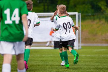 Kids Soccer Players Goal Celebration. Happy Children Playing Football Match. Young Boys on Sports Field